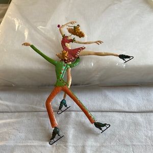 Metal Christmas ornaments of ice skaters.